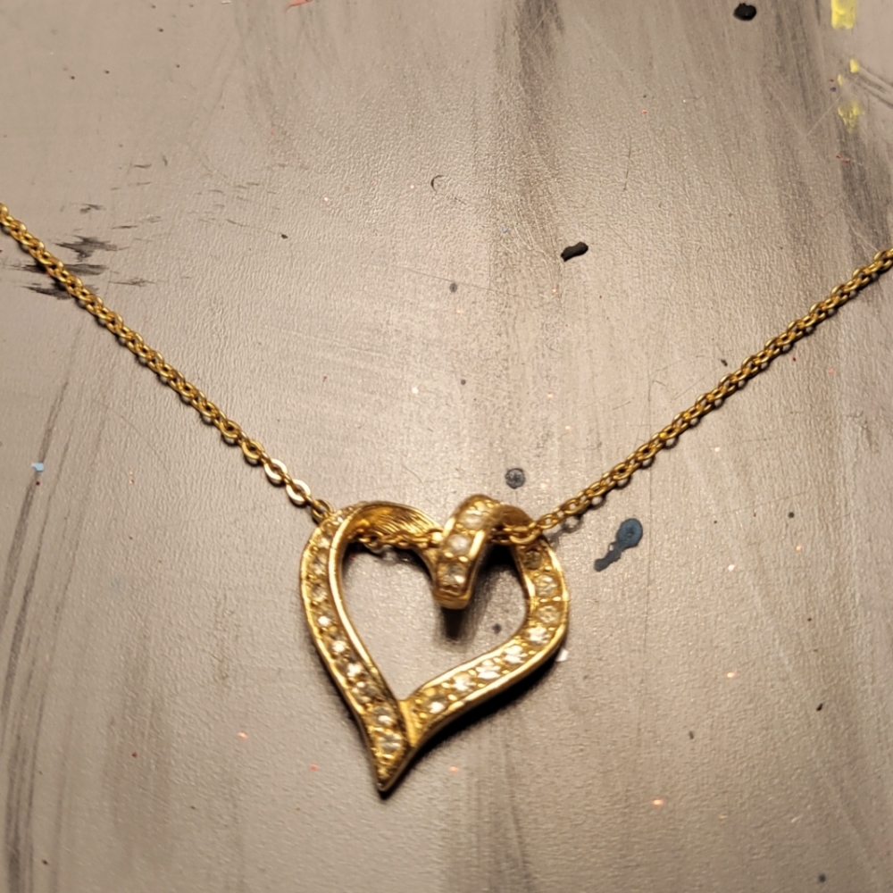 Costume heart pendent on gold chain.